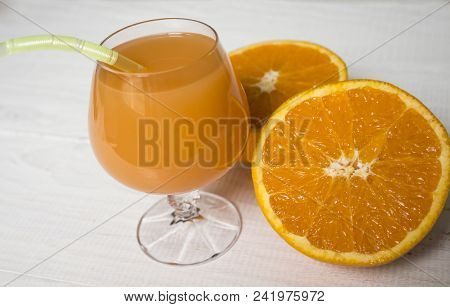 Glass Of Fresh Orange Juice,ripe Orange Fruit And Slices On Rustic Wooden Table.freshly Squeezed Ora