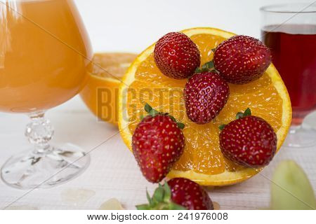 Glass Of Fresh Orange And Strawberry Juice,ripe Orange Fruit And Slices On Rustic Wooden Table.fresh