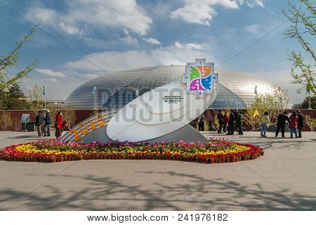 Beijing, China - April 27, 2010: White Statue With Emblem Of Opera Festival Surrounded By Flowers An