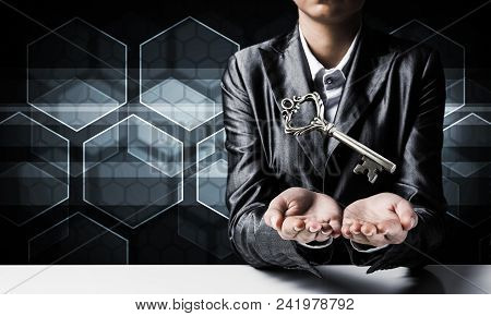 Cropped Image Of Businessman In Suit Keeping Big Key In Hands With Media Icons On Background.