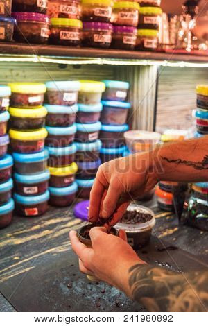 Shisha hookah preparing by barman. Bartender lays tobacco for smoking in hookah