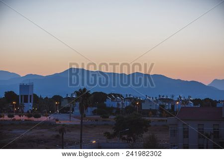 Dawn In Summer Over The City In The Mountains With Hanging Clouds On The Horizon At Sea. Turkey, Ala