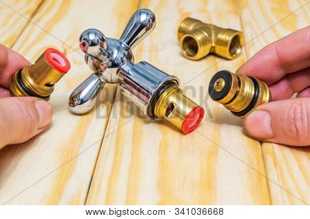 Cruciform Hot And Cold Water Main Switch Of Spare Parts Holding In His Hands Master Plumber Before R
