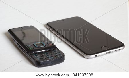 Bern, Switzerland, Dezember, 2019: Old Nokia Phone Next To Newer Iphone 7 On White Background.