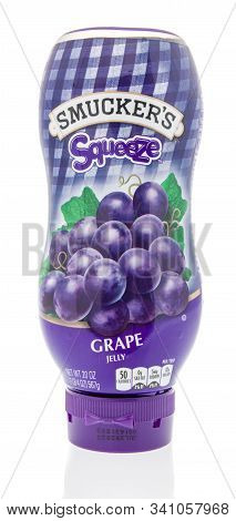 Winneconne, Wi - 3 December 2019 : A Bottle Of Smuckers Squeeze Grape Jelly On An Isolated Backgroun