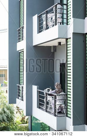 Pattalung, Thailand- Jannuary 26, 2019 : Woman With Phone And Laptop Sit At Hotel Balcony Working. B