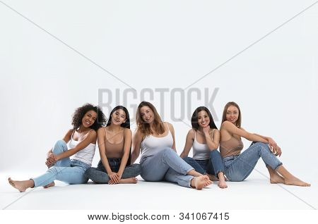 Group Of Women With Different Body Types On Light Background
