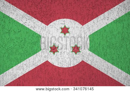 Burundi Flag Depicted In Bright Paint Colors On Old Relief Plastering Wall. Textured Banner On Rough