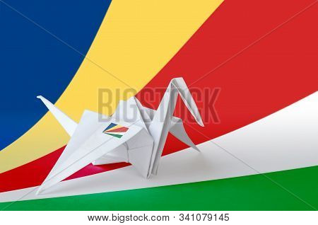 Seychelles Flag Depicted On Paper Origami Crane Wing. Handmade Arts Concept
