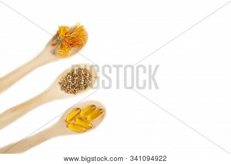 Herbal Capsule, Nature Vitamins, Mineral Supplement Pills At Wooden Spoon Isolated On White Backgrou