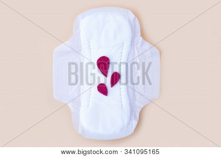 Protective Menstrual Pad With Fabric Blood Drops On Orange Background. The Concept Of Women Gynecolo