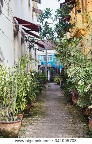 Panaji, India - December 15, 2019: A Narrow Lane Surrounded By Colorful Portuguese Houses In Panjim,