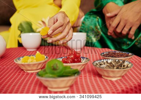 Small Bowls Withy Various Dried Fruits And Berries On Table In Front Of Couple Drinking Herbal Tea A