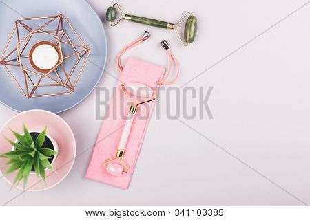 Beauty Composition With Trendy Pink And Green Jade Rollers On Blue Background. Selfcare, Home Spa An