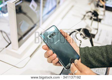 Turkey, Istanbul, December 20, 2019: The Buyer Takes A New Modern Samsung Phone And Wants To Buy It.