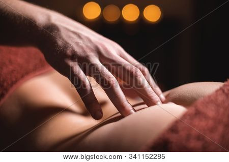 Close-up Male Hand Of A Professional Physiotherapist Massage Therapist Is Doing A Coccyx And Base Sp