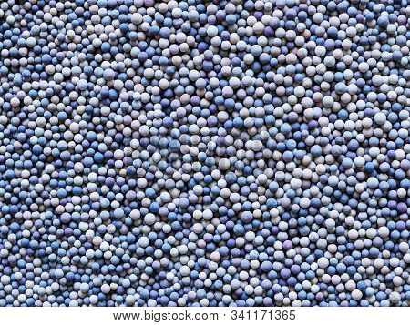 A Lot Of Tiny Ceramic Balls Or Granules In Color Range From Beige To Dark Blue As A Background. Grai