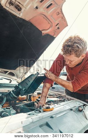 The Concept Of Disability Of People And Their Adaptation To Life. Blond Disabled Man Repairs The Eng