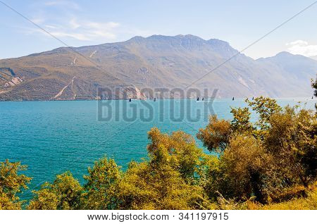 Garda Lake, Lombardy, Italy - September 12, 2019: High Black Sails Of Sailing Boats Moving Fast With