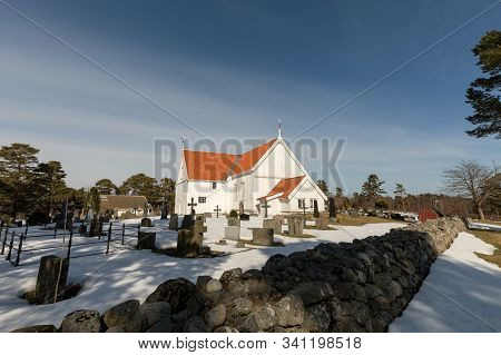 Tromoy Church At Hove, Tromoy In Arendal, Norway. White Church, Blue Sky, Sunny Day.