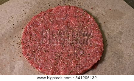 Cook Makes Meat Medallions For Burgers. Chef In Black Food Gloves Makes Cutlet. Cutlets Are Leveled 