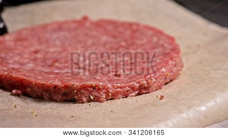 Cook Makes Meat Medallions For Burgers. Chef In Black Food Gloves Makes Cutlet. Cutlets Are Leveled 