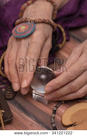 Woman Fortune Teller Holds A Ball Of Fate In Her Hands, A Magic Ball Of Predictions. The Concept Of 
