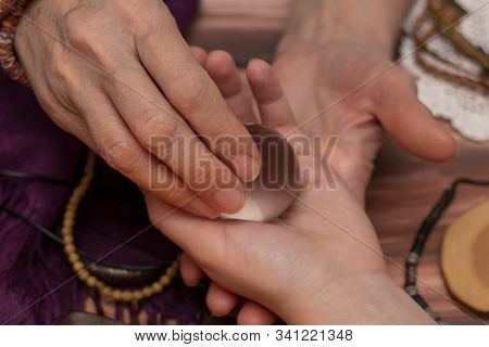 Woman Fortuneteller Puts A Ball Of Fate In Her Hand, A Magic Ball Of Predictions. The Concept Of Pre