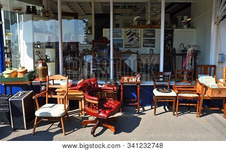 Felixstowe, Suffolk, England - April 21, 2019: Antique Shop With Furniture On Pavement Outside.