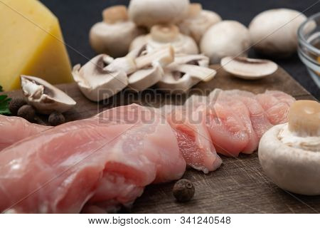 Slicing Chicken Breast Fillet For Cooking With Champignons And Cheese