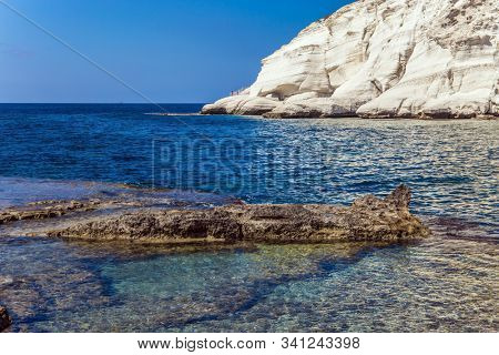 The border between Israel and Lebanon. The color of sea water from azure to dark blue. Rocky bay near chalk mountain Rosh a Nikra in northern Israel. The concept of eco and photo tourism
