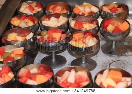 Fresh Fruit In Metal Bowls A Selfservice Cruise Ship Buffet: Melon, Pineapple And Grapes