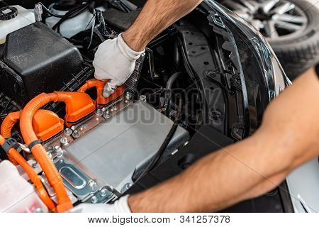 Cropped View Of Mechanic Inspecting Car Engine Compartment