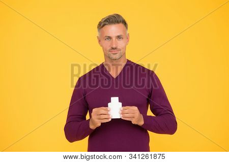 Body Odor Care. Handsome Man Hold Lotion Or Bodywash Bottle. Presenting Personal Hygiene Care Produc