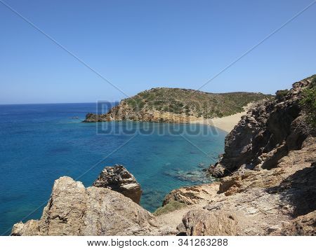 Beautiful View Of The Stone Coast Against The Blue Sea