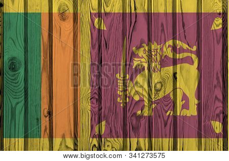 Sri Lanka Flag Depicted In Bright Paint Colors On Old Wooden Wall. Textured Banner On Rough Backgrou