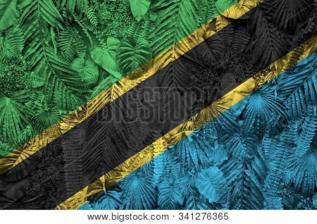 Tanzania Flag Depicted On Many Leafs Of Monstera Palm Trees. Trendy Fashionable Backdrop