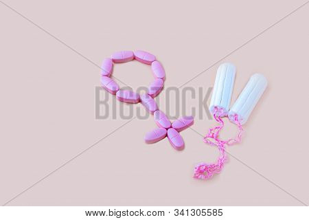 Protective Menstrual Cotton Tampons And Gender Symbol Made From Pink Pain Pills. The Concept Of Wome