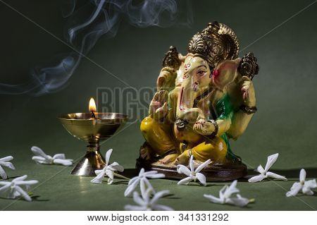 Hindu God Ganesha. Ganesha Idol. A Colorful Statue Of Ganesha Idol On Dark Background. Space For Tex