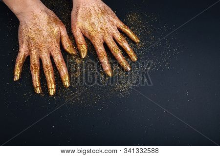 Beautiful Hands In Golden Paint On Black Fastive Background Close Up