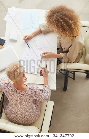 Two Unrecognizable Businesswomen Having Disscusion On New Project Issue Vertical From Above Shot