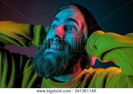 Exremely Shocked, Astonished. Caucasian Mans Portrait On Gradient Studio Background In Neon Light. B