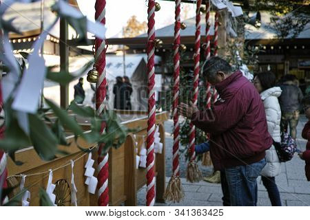 Chichibu, Japan - 4 1 2019: A Man In Prayer At A Shinto Shrine In Japan