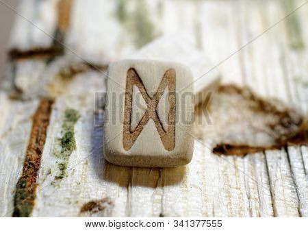 Wooden Rune Dagaz Close-up On A Wooden Background. Soft Focus
