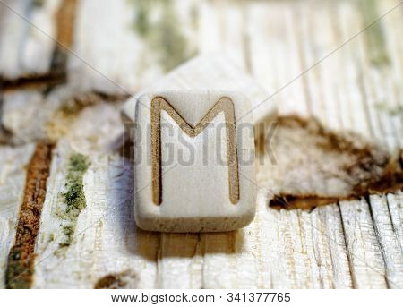 Wooden Rune Ehwaz Close-up On A Wooden Background. Soft Focus