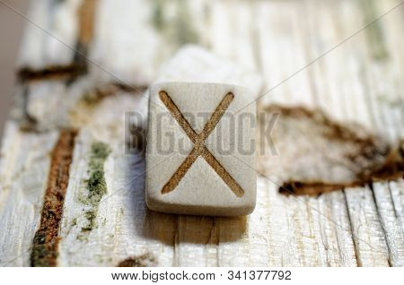 Wooden Rune Gebo Close-up On A Wooden Background. Soft Focus
