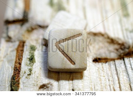 Wooden Rune Kano Close-up On A Wooden Background. Soft Focus
