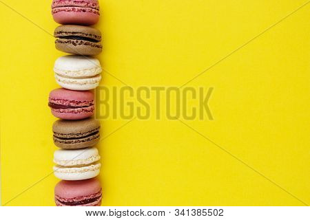 Macarons Cakes. Fashion Or Feminine Background Delicious Macaroons In Row On Yellow Background. Soci