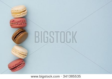 Macarons Cakes. Fashion Or Feminine Background Delicious Macaroons In Row On Blue Background. Social