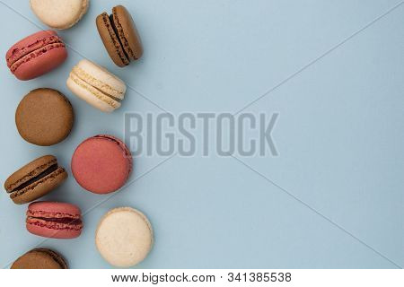 Macarons Cakes. Fashion Or Feminine Background Delicious Macaroons In Row On Blue Background. Social